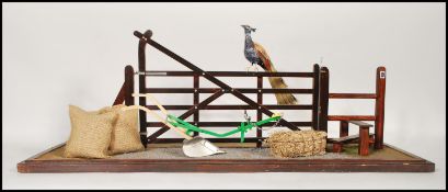 A 20th Century scratchbuilt folk art style diorama of a farmyard scene displaying farmyard machinery
