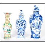 A group of three 19th Century Chinese vases / urns, one being famille jaune and verte having central