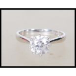 An 18ct white gold single stone solitaire ring having a central claw set round cut diamond with