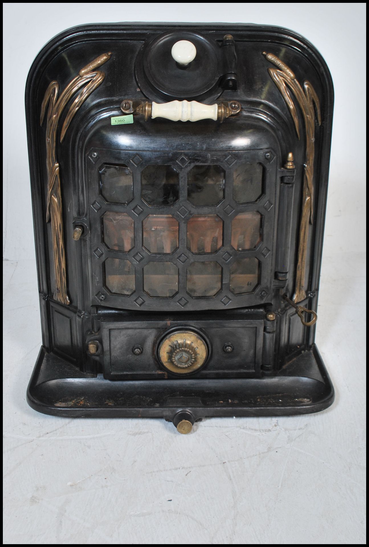 An early 20th Century antique La Salamandre stove having gilt reed decoration with a paneled glass - Image 2 of 5