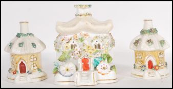 A group of three 19th Century Staffordshire porcelain pastille burners in the form of cottages to