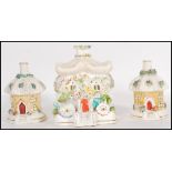 A group of three 19th Century Staffordshire porcelain pastille burners in the form of cottages to