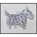 A sterling silver and marcasite pendant in the form of Scottish Terrier 'Scottie' dog having red