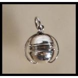 A stamped 925 silver metamorphic locket pendant of orb form opening to reveal storage for four