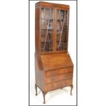 A 20th Century Georgian style Regency Revival mahogany bureau bookcase having twin astragal glazed