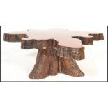 A vintage 20th Century live edge Cypress wood coffee table constructed from a cross section of a