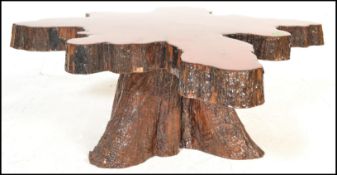 A vintage 20th Century live edge Cypress wood coffee table constructed from a cross section of a