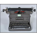 A Vintage early 20th Century Circa 1930s industrial Typewriter machine by "Royal" having glass set