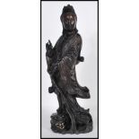 An early 20th Century Chinese carved figurine of  female immortal figure holding one hand aloft