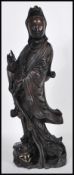 An early 20th Century Chinese carved figurine of  female immortal figure holding one hand aloft