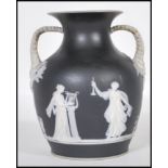 A 19th Century Victorian basalt black jasperware portland vase of small proportions having applied