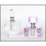 Two early 20th Century Art Deco faceted cut glass perfume bottles, one having a purple finish with