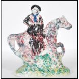 An early 19th century Staffordshire ' flatback ' style pottery figure of a woman riding a horse.