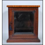 An early 20th Century 1930's mahogany smokers cabinet having satinwood inlaid flared top. The single