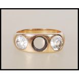 A stamped 18ct gold ring set with two round cut wh