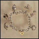 A silver hallmarked heart lock charm bracelet having six charms including a viking ship, pair of