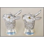 A pair of silver salt and pepper condiments in the form of hares having glass eyes. Stamped to bases