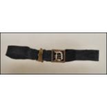 A 19th Century Victorian mourning bracelet constructed from a black ribbon with a stamped 9ct gold