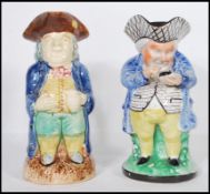 Two 19th Century Staffordshire Toby character jugs each being hand painted with tricorn hats.
