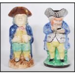 Two 19th Century Staffordshire Toby character jugs each being hand painted with tricorn hats.