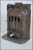 An early 20th Century La Salamandre antique wood burner gas stove, mounted on wheels having raised