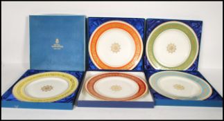 A collection of five commemorative cased Royal Worcester plates given to members of staff for