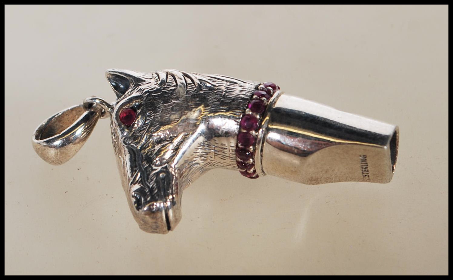 A silver novelty whistle pendant in the form of a horse head set with ruby eyes and having a ruby - Image 4 of 6