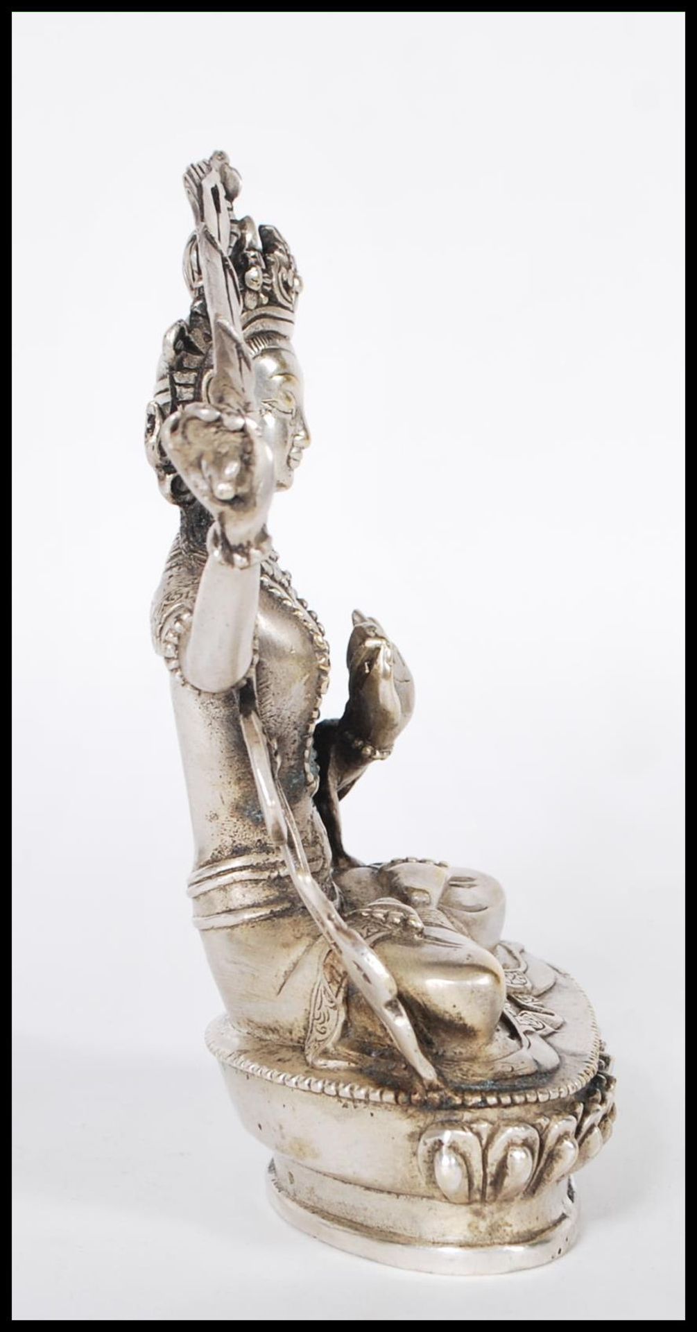 A 20th Century Tibetan white brass figure of Bodhisattva Manjushri seated crossed legged on a - Bild 2 aus 6