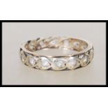 A 20th Century 9ct two tone eternity ring being set with white stones. Unmarked but tests as 9ct