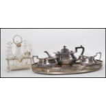 An early 20th Century three piece silver plated tea service set to a gallery twin handled silver