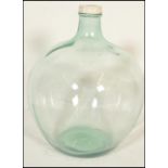 A retro 20th century large bulbous glass acid carboy bottle with thin waisted neck with original