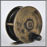 An early 20th Century Hardy Bros fly fishing reel having a brass foot with a single black handle.