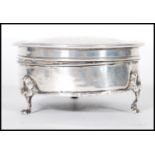 An English hallmarked dressing table trinket pot of round form having a domed lid raised on three