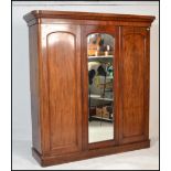 A Victorian mahogany triple wardrobe linen press c