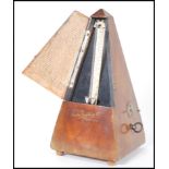 A vintage 20th Century Triangular cased wooden metronome with applied brass mounts Metronome by