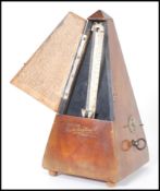 A vintage 20th Century Triangular cased wooden metronome with applied brass mounts Metronome by