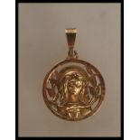 An 18ct gold unmarked Madonna pendant having to include a round pendant with pierced decoration.