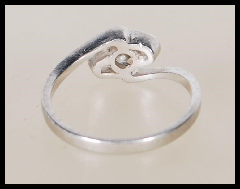 A 950 platinum solitaire diamond ring having an openwork swirl mount set with a single diamond - Image 3 of 6