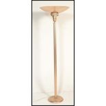 An Art Deco style standard lamp / uplighter having corinthian style column with demilune shade atop,