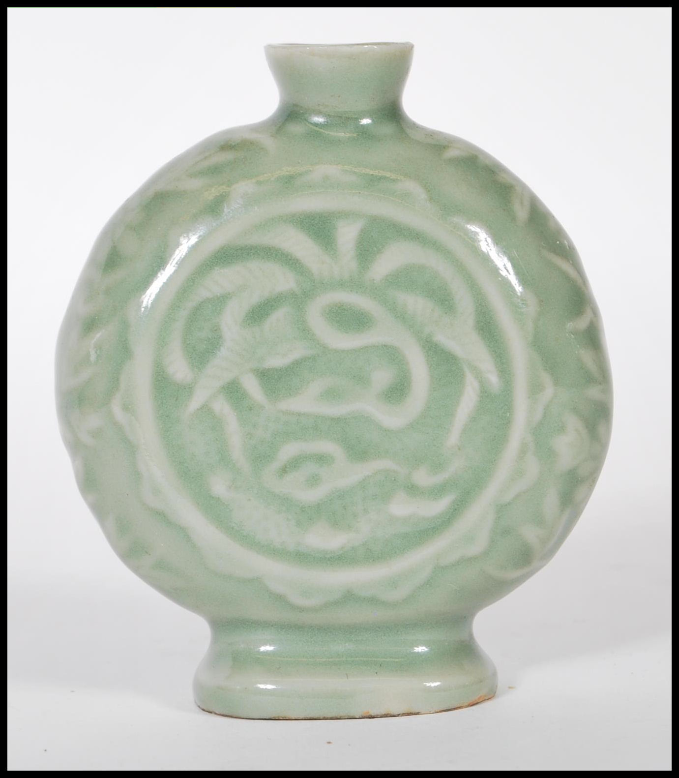 A 19th Century Chinese ceramic bottle / moon flask having a green glaze finish with floral relief - Image 2 of 7