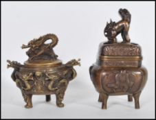 Two 20th Century Chinese incense burners one of brass construction decorated in relief with