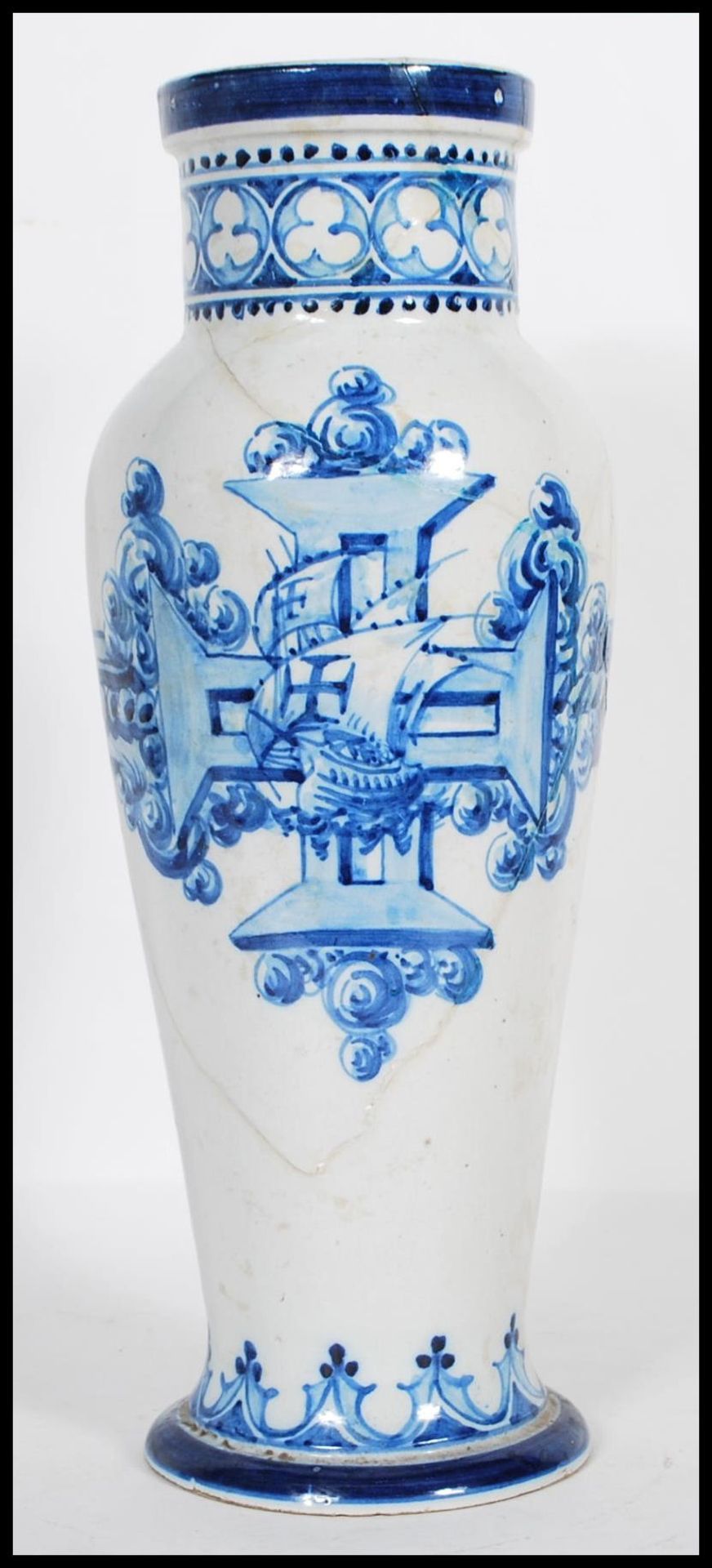 A 19th Century Italian faience vase of tapering form painted with a central cross and naval boat