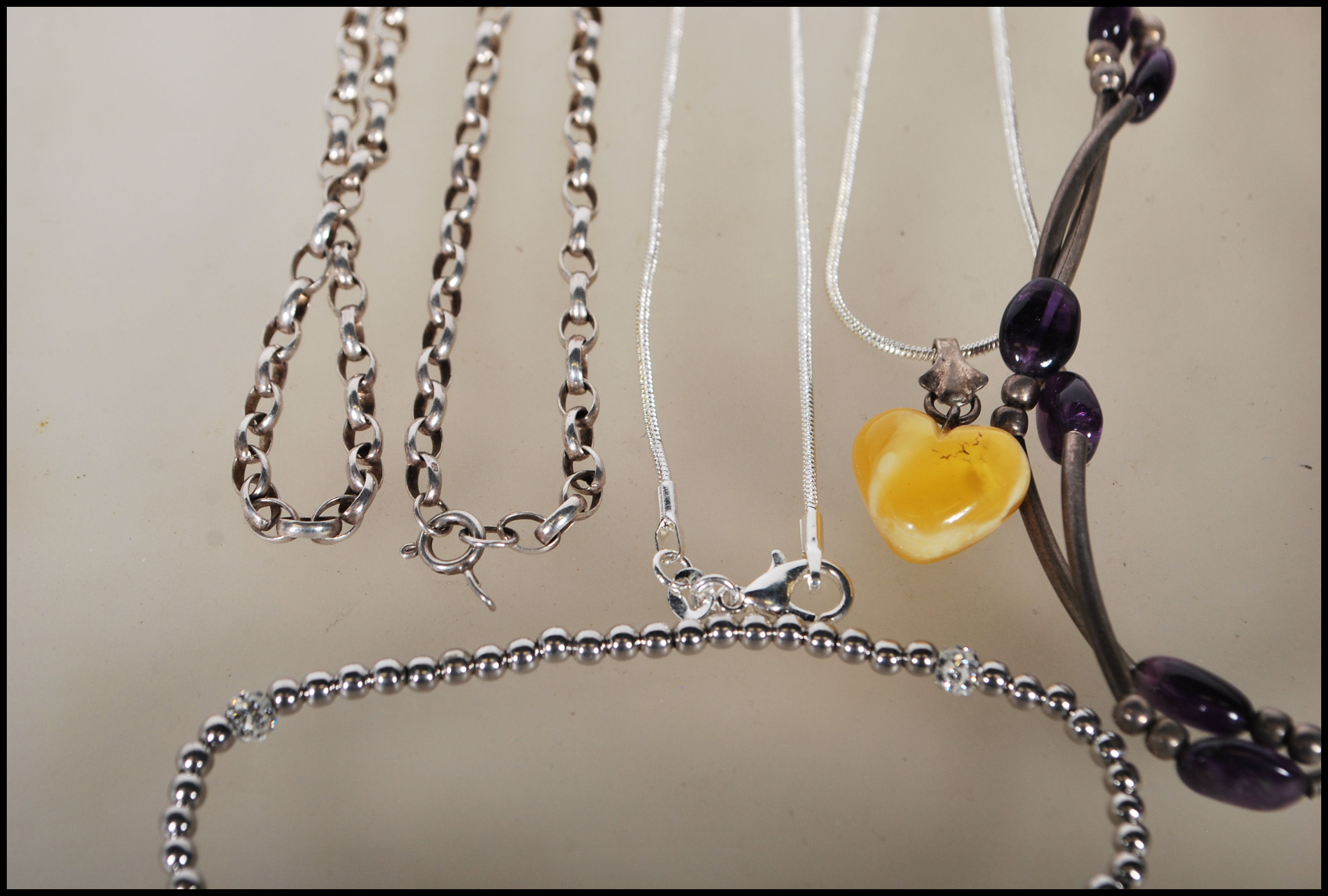 A selection of silver necklaces to include a spacer necklace with purple beads, a snake chain - Image 7 of 8
