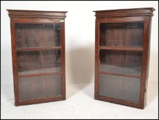 Two 20th Century hardwood apothecary / display wall mounted cabinets having sectional glazed doors