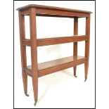 A 19th Century Victorian three tier bookshelf of rectangular form, raised on tapering supports