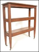 A 19th Century Victorian three tier bookshelf of rectangular form, raised on tapering supports