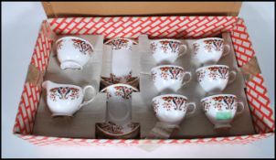 A vintage Coclough tea service consisting of tea cups and saucers having red and blue Imari style