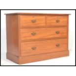 An early 20th Century Edwardian cottage walnut chest of drawers, two short drawers over two long