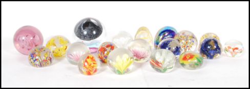 A collection of 19 vintage retro 20th Century glass paperweights of various designs to include