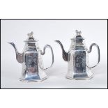 A pair of heavy cast matching silver plated Chinese teapots, the teapots with scroll spouts and